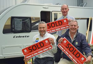 Salop Leisure sales executives (from left) Paul Simpson, George Harris and Stuart Edwards celebrate their success at the National Motorhome and Caravan Show