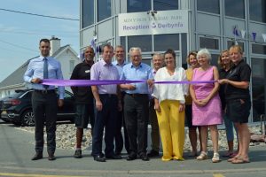 Minister for Culture, Tourism and Sport Lord Elis-Thomas cuts a ribbon to officially open the new Min-y-Don Holiday Park reception facility with Salop Caravans Sites chairman Tony Bywater, managing director Dylan Roberts, park managers Carl and Jayne Mill