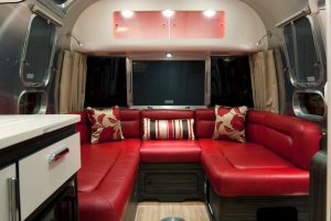 The interior of the Airstream caravan boasts dedicated space for laptops and books