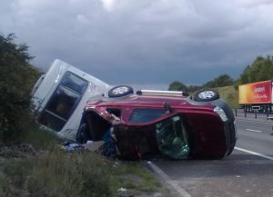 A flipped towing car and caravan