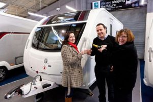 Tina Ennis of Ennis Caravans (left) celebrates with Mr and Mrs Lloyd