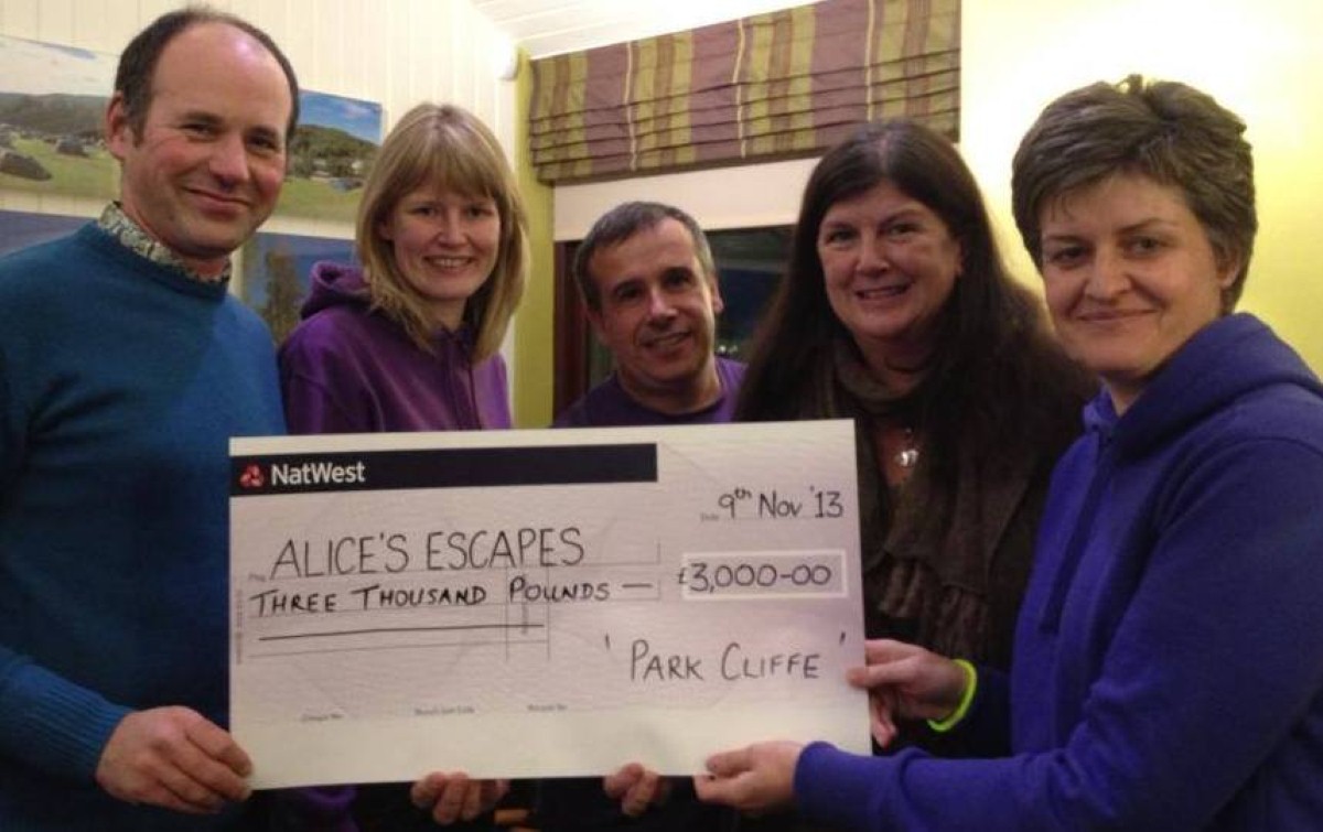 Susan Dickson (far right) hands over the cheque to the charity's trustees