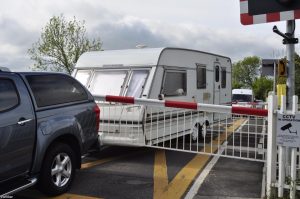 Not what they bargained for: caravan gets stuck while travelling over level crossing