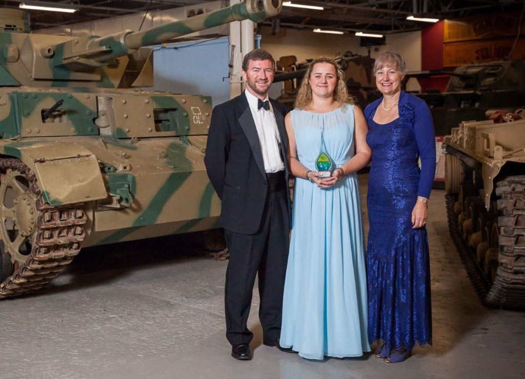 Tony and Sarah Birch with (centre) their daughter Chrissy receive their award at the Bovington Tank Museum