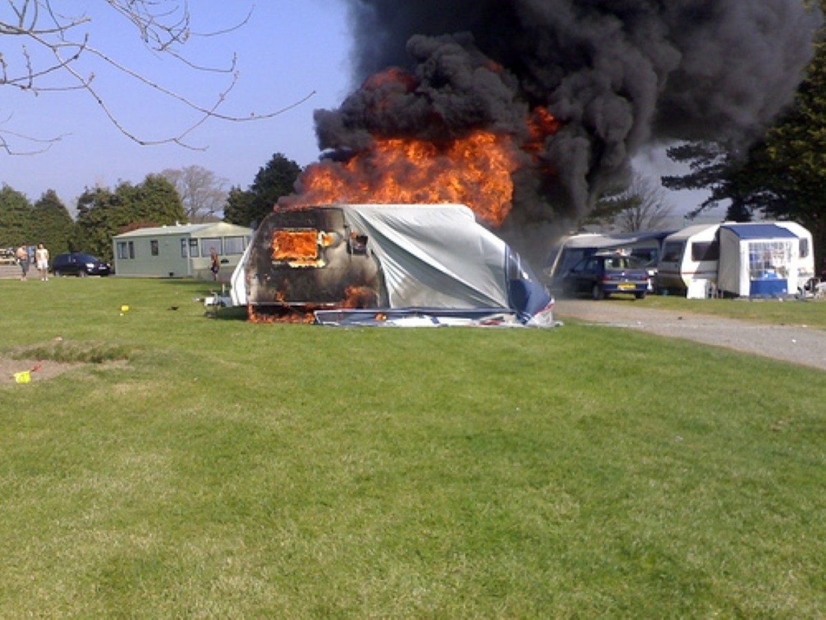 An unnamed man was pulled from an inferno at a caravan site in Wales