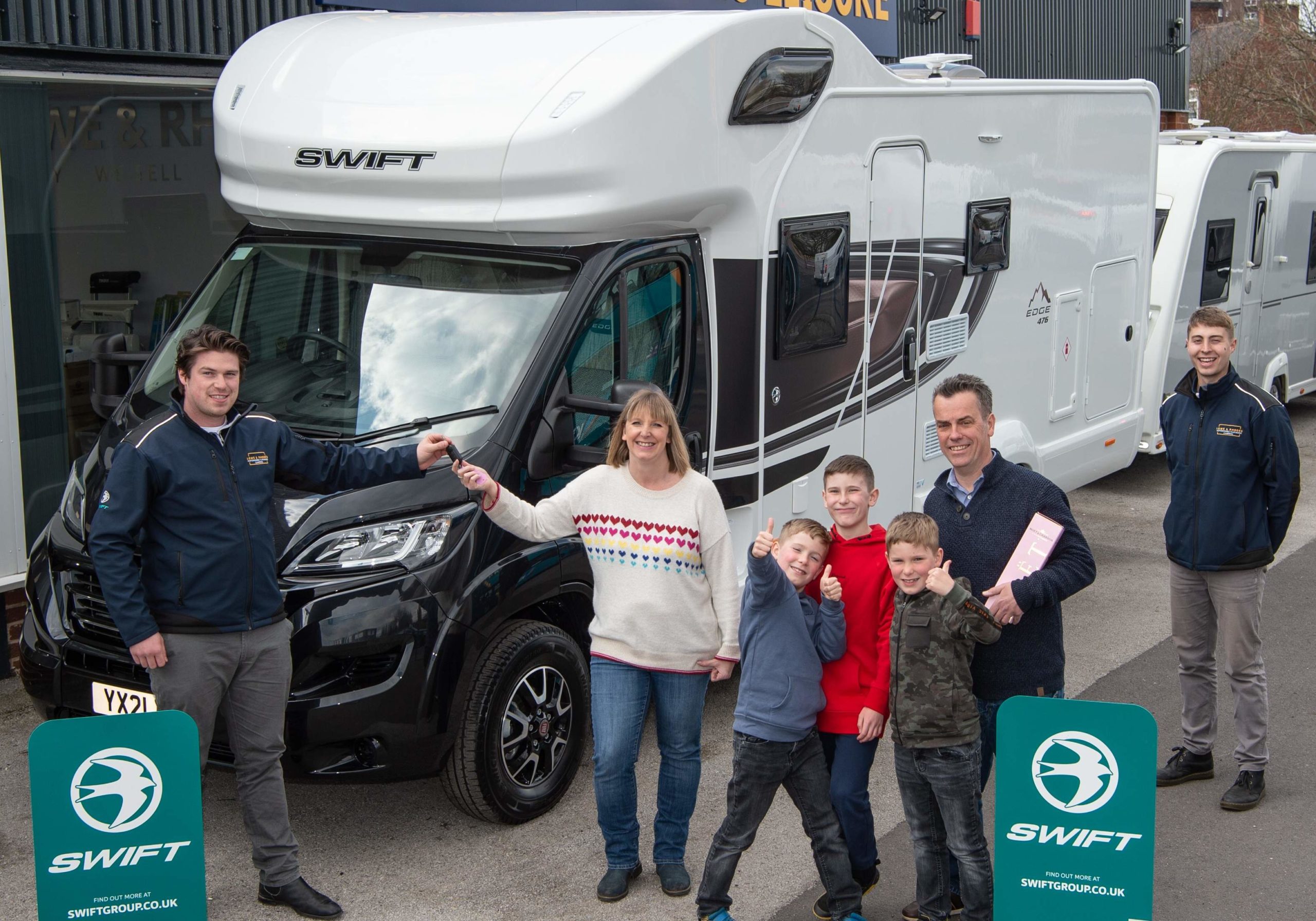 The Lear family taking receipt of their Swift Edge 476 motorhome