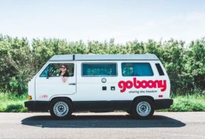Woman inside a motorhome emblazoned with the GoBoony logo