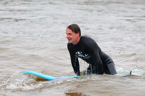 Andrew Lincoln surfing in North Wales
