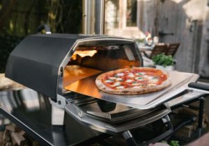 An Ooni pizza oven in action