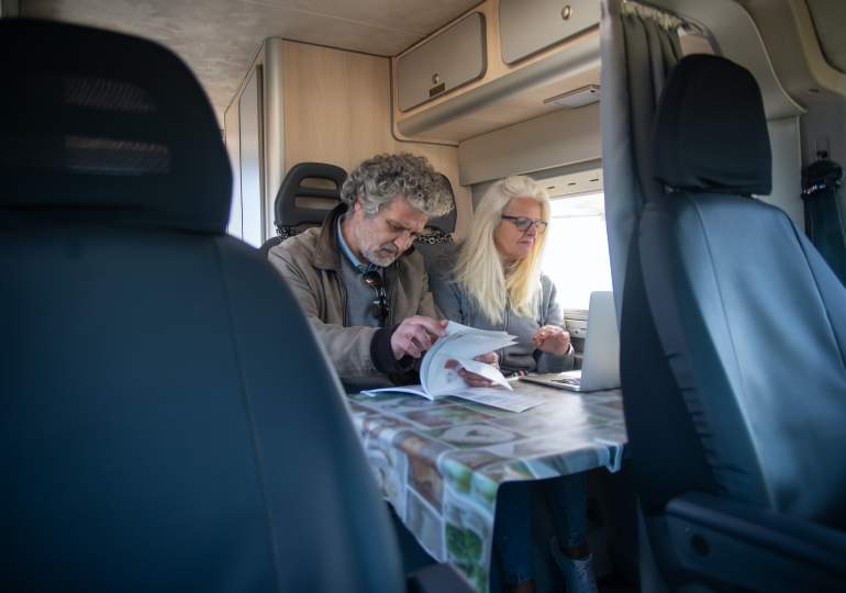 A couple sitting in a motorhome