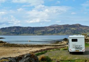 A motorhome parked by a loch in Scotland