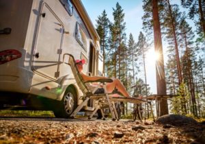 Woman enjoying the sunshine outside her motorhome