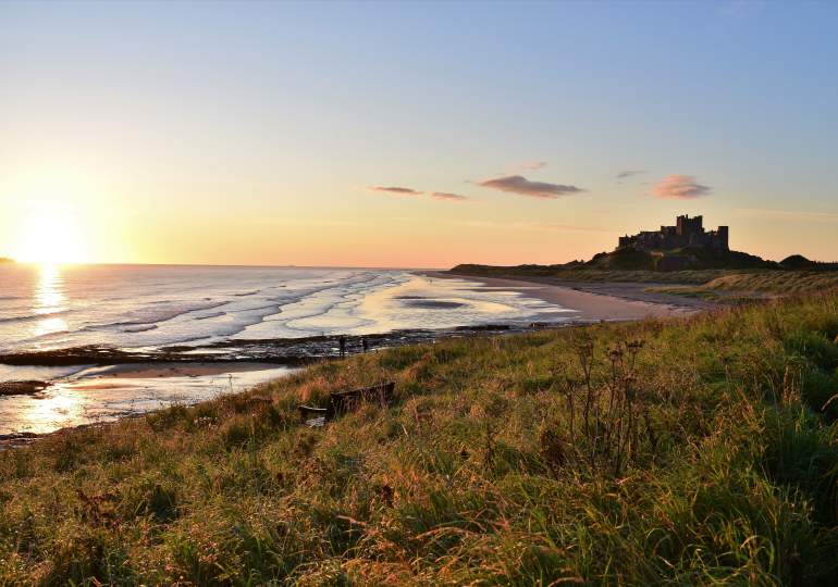 Bamburgh Castle and beach at dusk
