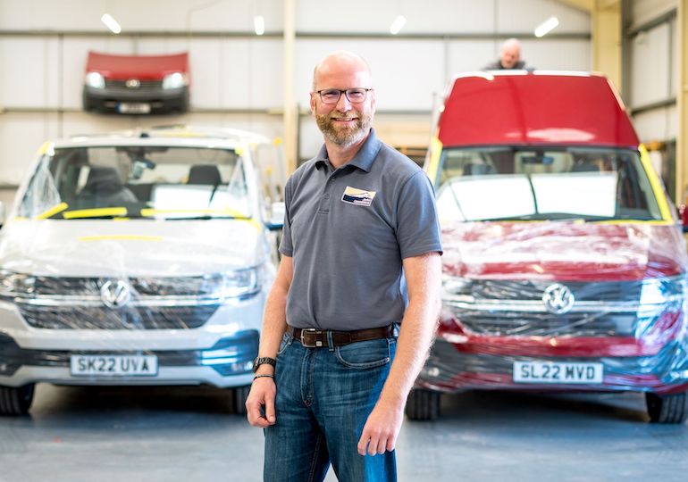Paul Kimberlin standing in front of camper vans