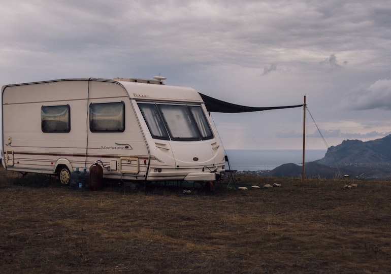 A caravan set up with an awning