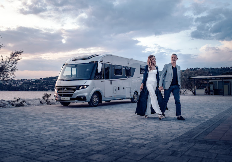 Couple walking away from the Adria Supersonic motorhome