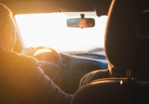 A driver behind the wheel of a car