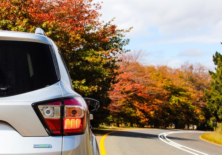 Towcar driving through autumnal countryside