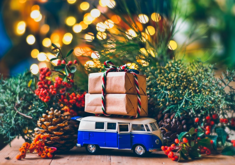 A toy campervan loaded with Christmas parcels