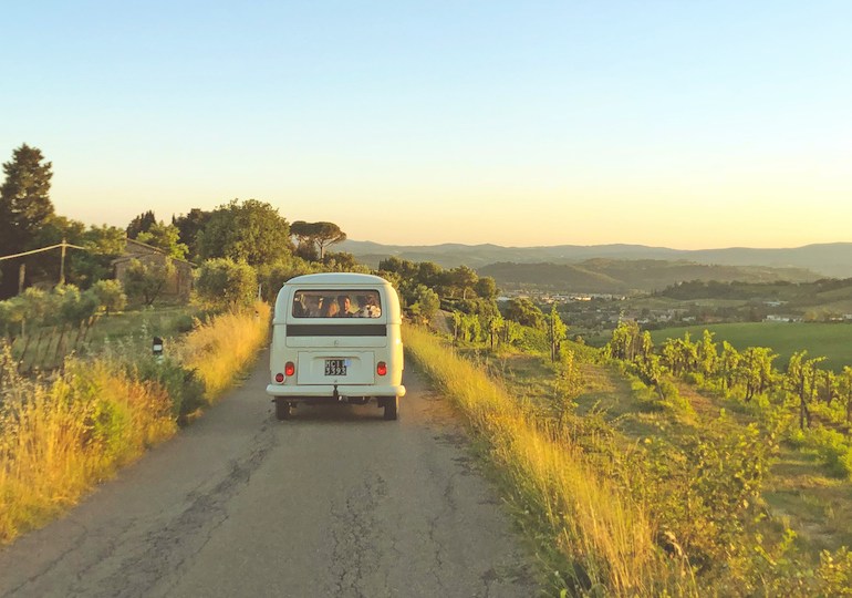 A camper van driving down an Italian road