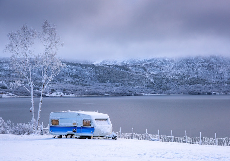 Caravan against a snowy backdrop