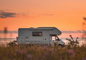 A motorhome against a sunset backdrop