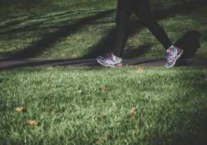 Woman in trainers walking in a park