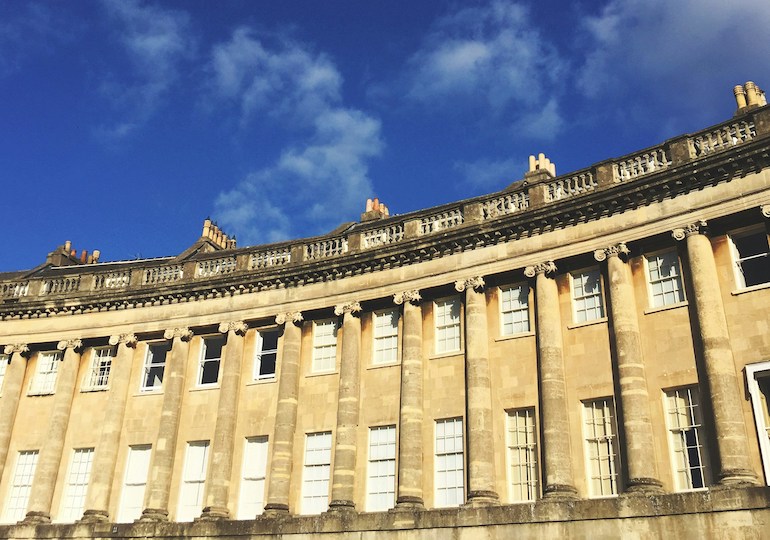A section of Bath's Royal Crescent, with blue sky behind