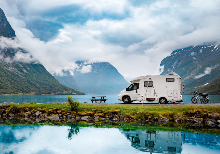 A motorhome parked up by a lake