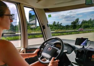 A woman driving a motorhome