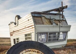 A crashed caravan on its roof