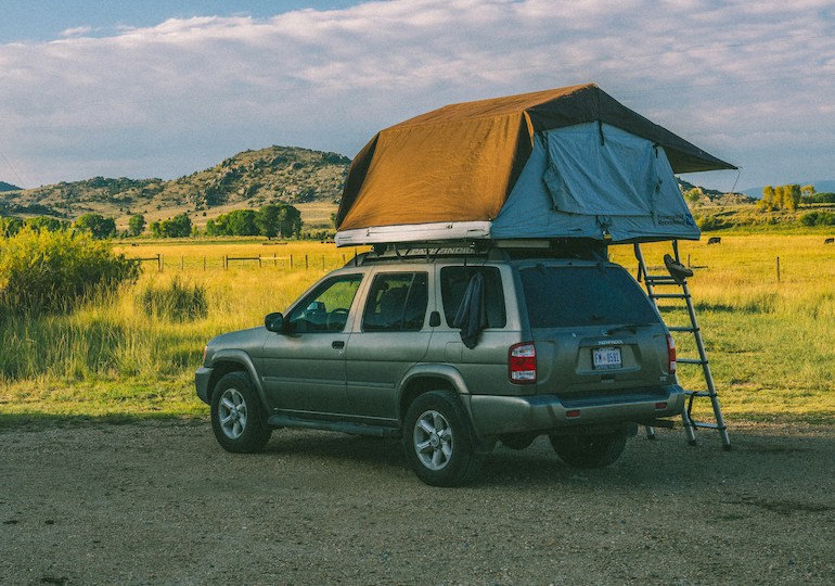 A roof tent atop a parked car